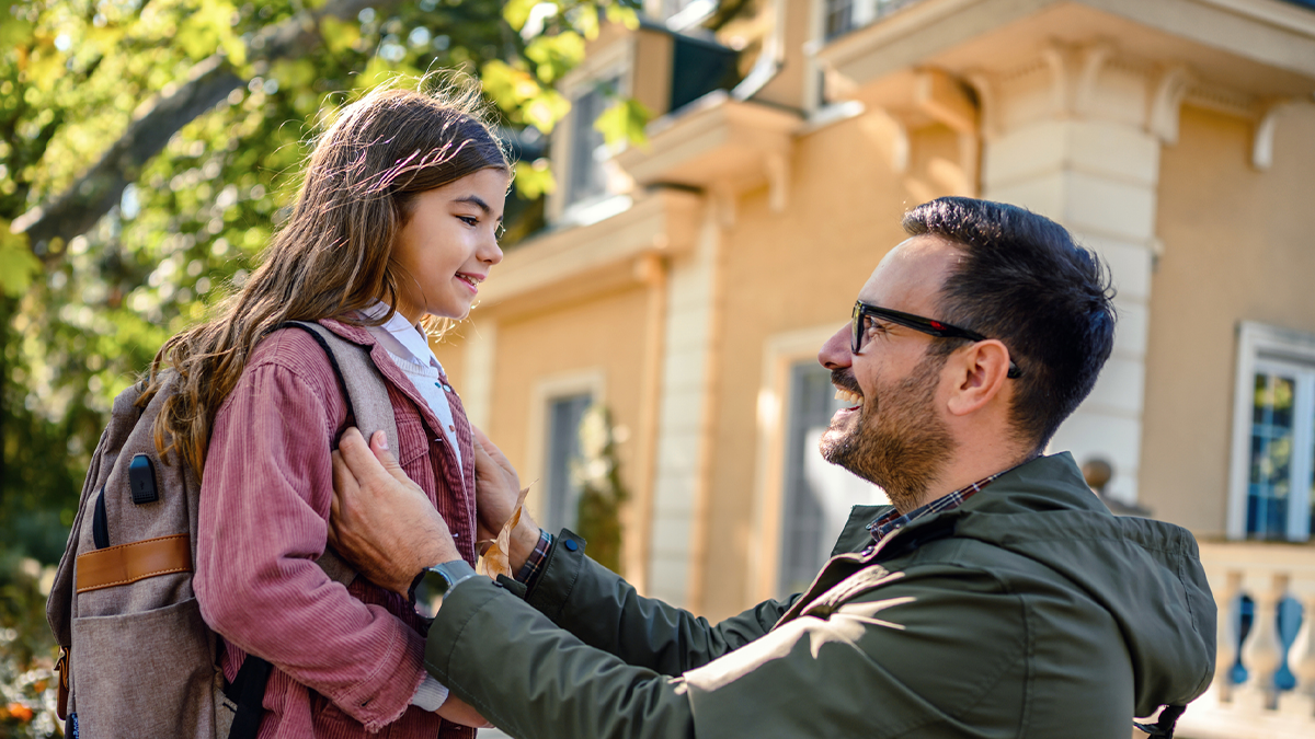— title missing — A father is saying goodbye to his daughter before she goes to school