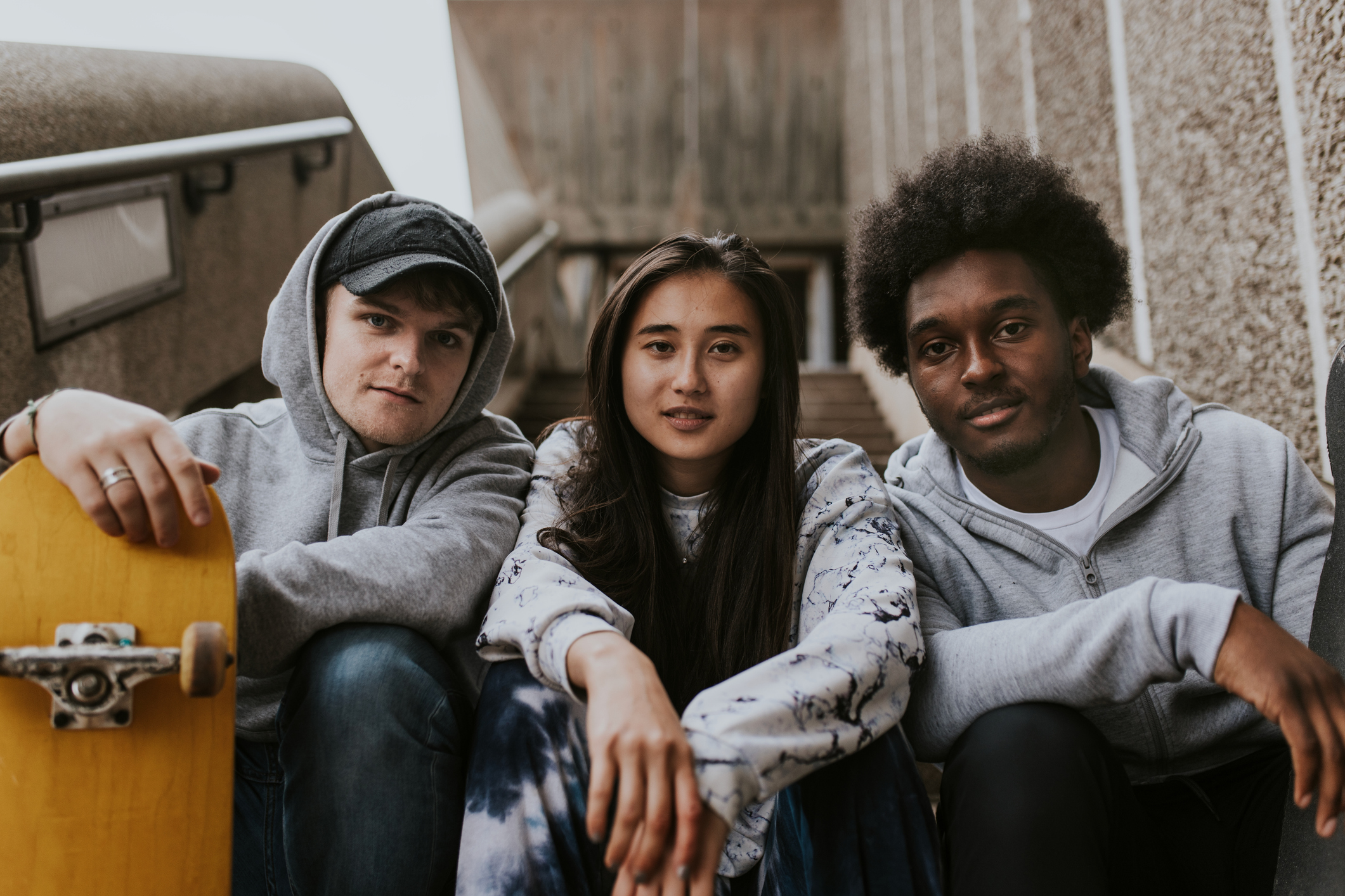 Diverse group of youth sitting on staircase A diverse group of youth sitting on stairs.