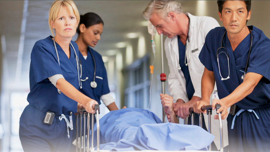Hospital clinicians Doctors push a patient laying in a hospital bed